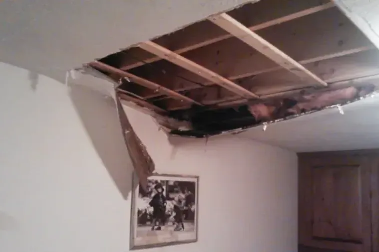Ceiling opened so the framing can dry after a leak from above