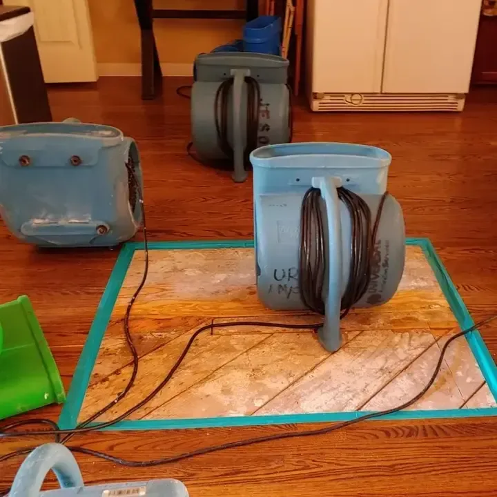 Dehumidifier and air movers drying a stripped condo unit