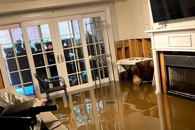 Muddy storm water spread across a living room floor