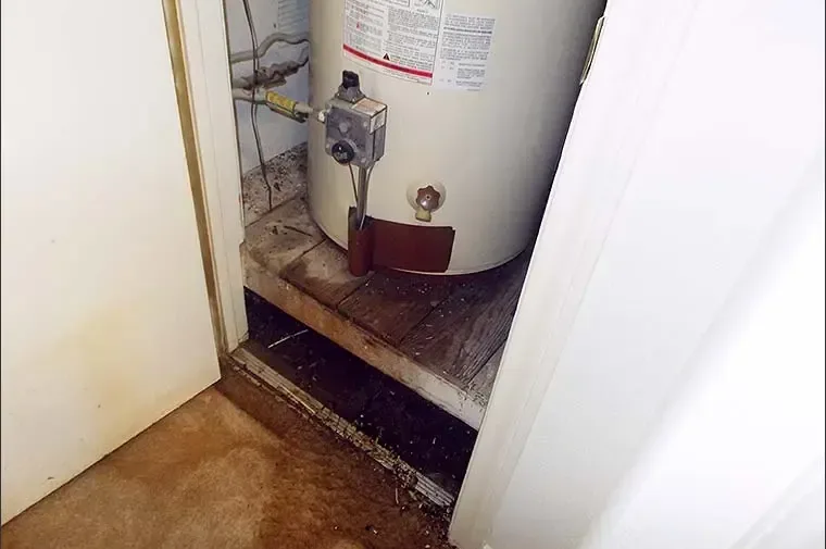 Water heater closet with a soaked floor after the tank leaked
